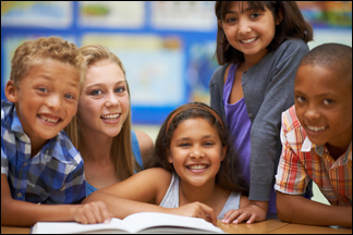 Students reading a book and smiling